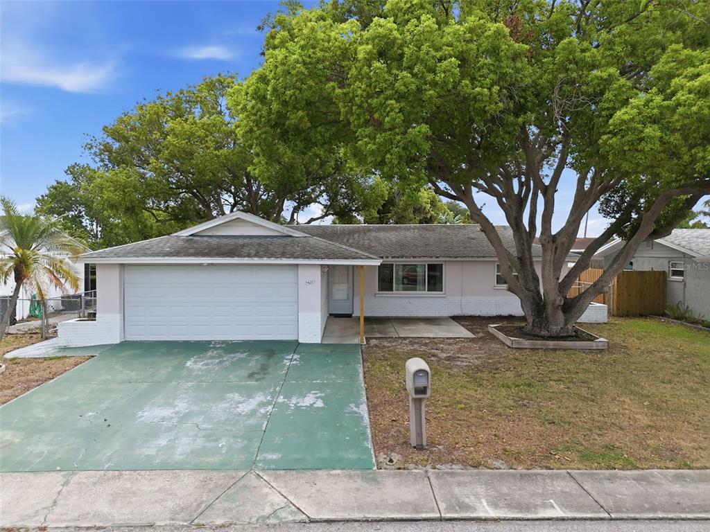 9420 Glen Moor Lane Port Richey, FL 34668 - Photo 1 of 36 a front view of a house with a yard