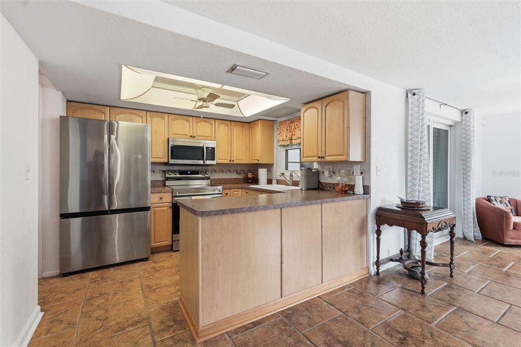 9420 Glen Moor Lane Port Richey, FL 34668 - Photo 11 of 36 a kitchen with stainless steel appliances granite countertop a refrigerator stove microwave and sink