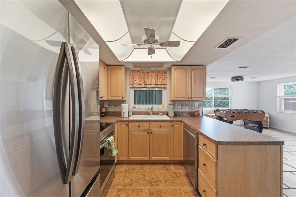 9420 Glen Moor Lane Port Richey, FL 34668 - Photo 12 of 36 a kitchen with stainless steel appliances granite countertop a sink stove refrigerator and cabinets