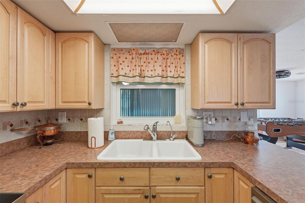 9420 Glen Moor Lane Port Richey, FL 34668 - Photo 15 of 36 a kitchen with granite countertop a sink stainless steel appliances and cabinets