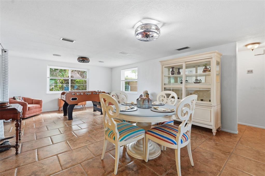 9420 Glen Moor Lane Port Richey, FL 34668 - Photo 16 of 36 a living room with furniture a dining table and a window