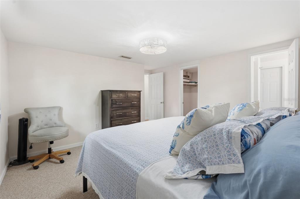 9420 Glen Moor Lane Port Richey, FL 34668 - Photo 22 of 36 a bedroom with a bed and furniture
