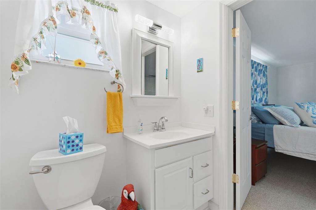 9420 Glen Moor Lane Port Richey, FL 34668 - Photo 24 of 36 a bathroom with a sink a toilet and a mirror