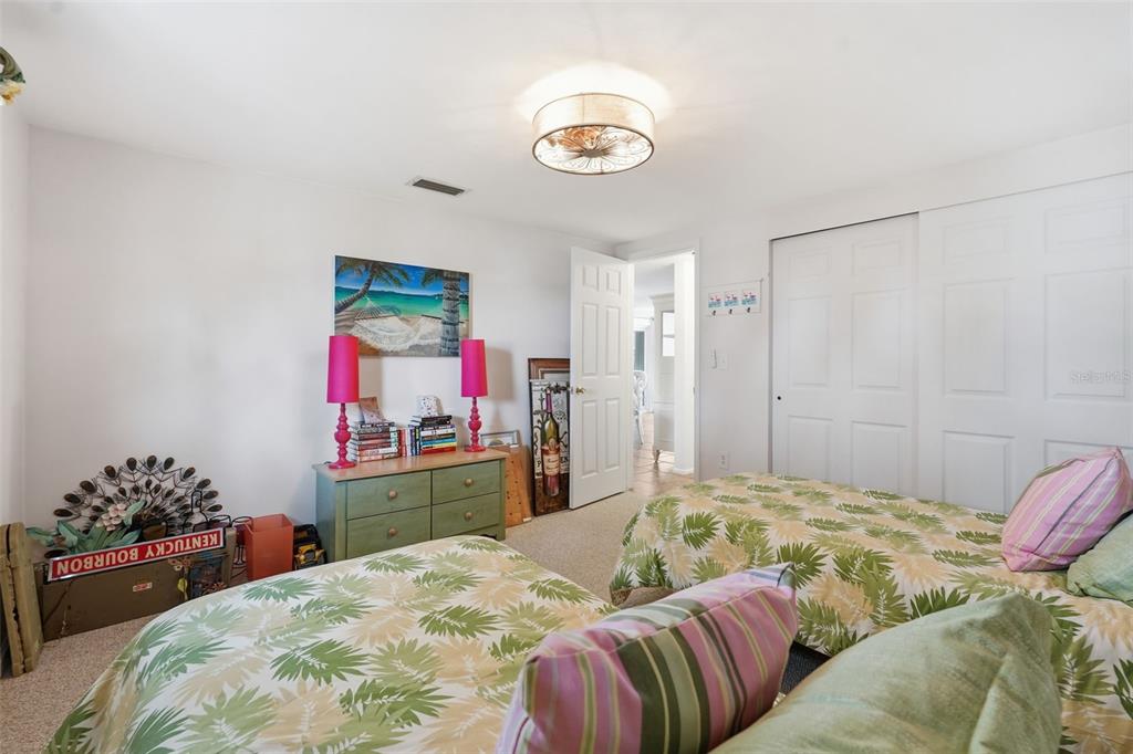 9420 Glen Moor Lane Port Richey, FL 34668 - Photo 28 of 36 a bedroom with a bed and a dresser