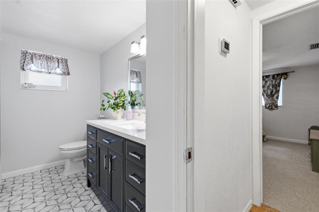 9420 Glen Moor Lane Port Richey, FL 34668 - Photo 29 of 36 a bathroom with a sink a toilet and a mirror
