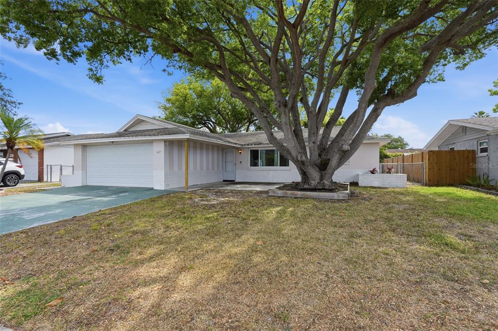 9420 Glen Moor Lane Port Richey, FL 34668 - Photo 3 of 36 a view of a house with a yard