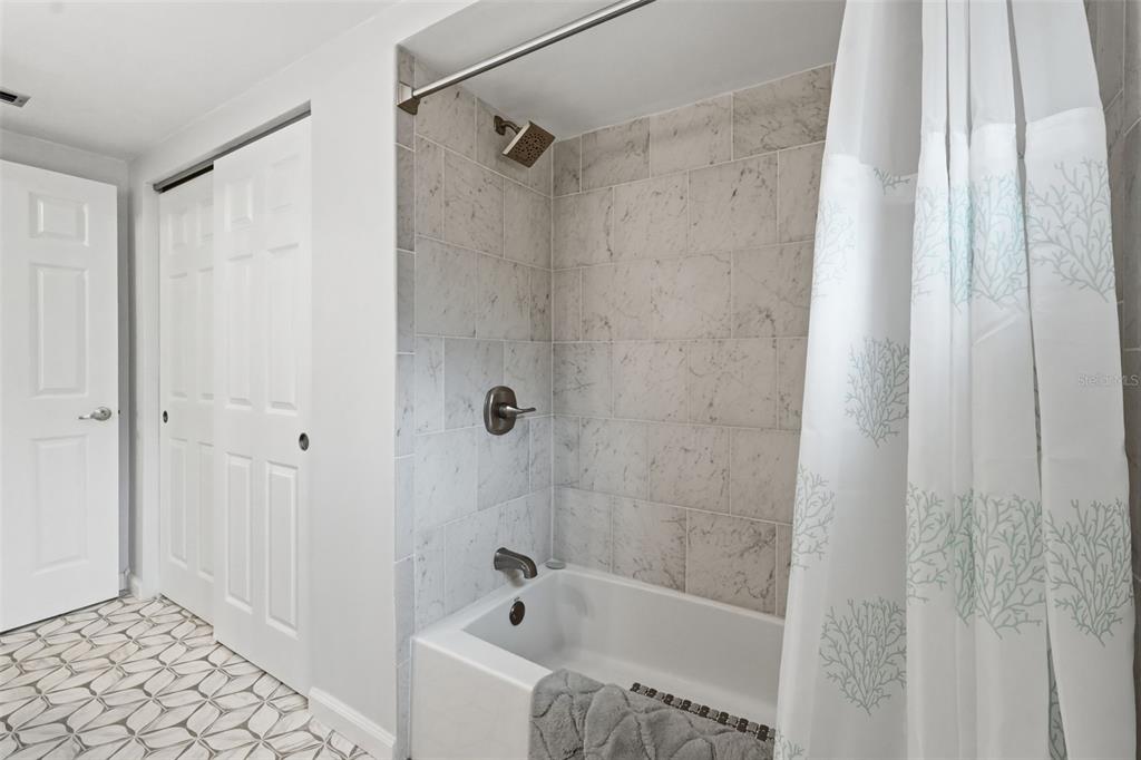 9420 Glen Moor Lane Port Richey, FL 34668 - Photo 32 of 36 a bathroom with a bathtub and a shower