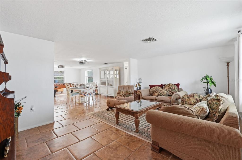 9420 Glen Moor Lane Port Richey, FL 34668 - Photo 7 of 36 a living room with furniture and wooden floor