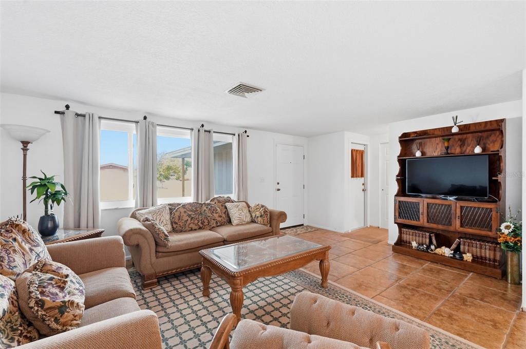 9420 Glen Moor Lane Port Richey, FL 34668 - Photo 9 of 36 a living room with furniture and a flat screen tv