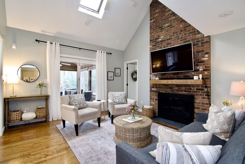 215 Maynard Road Wilbraham, MA 01095 - Photo 15 of 42 a living room with furniture a fireplace and a flat screen tv