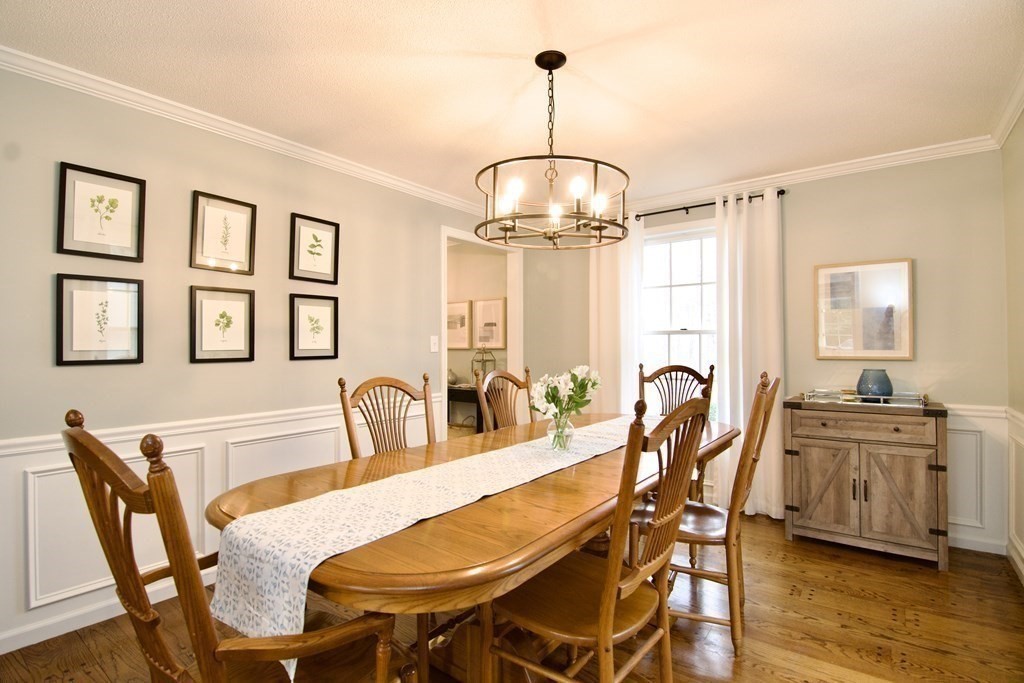 215 Maynard Road Wilbraham, MA 01095 - Photo 22 of 42 a dining room with furniture a chandelier and wooden floor