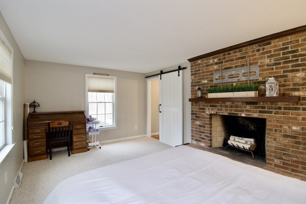 215 Maynard Road Wilbraham, MA 01095 - Photo 25 of 42 a living room with furniture and a fireplace