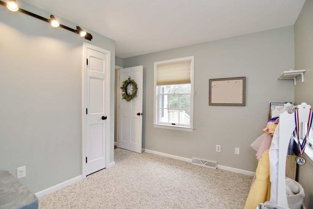 215 Maynard Road Wilbraham, MA 01095 - Photo 27 of 42 a view of a bedroom with wooden floor and windows