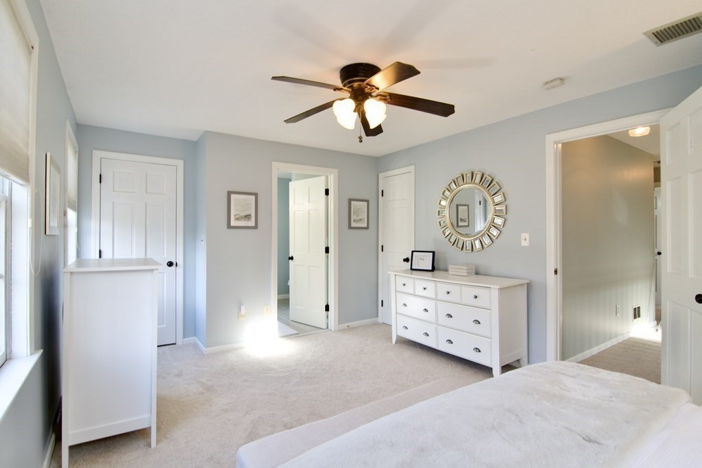 215 Maynard Road Wilbraham, MA 01095 - Photo 36 of 42 a bedroom with a bed and a chandelier