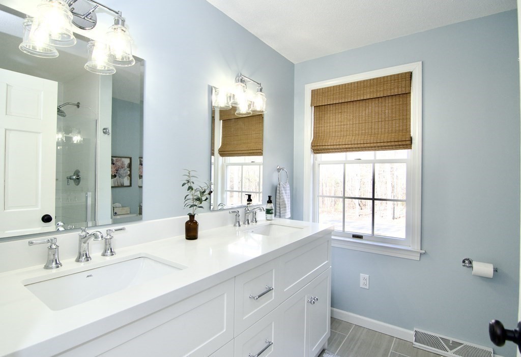 215 Maynard Road Wilbraham, MA 01095 - Photo 37 of 42 a bathroom with double vanity sinks a vanity and a mirror