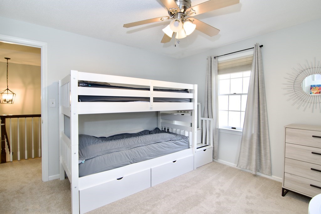 215 Maynard Road Wilbraham, MA 01095 - Photo 38 of 42 a bedroom with a bed and a chandelier