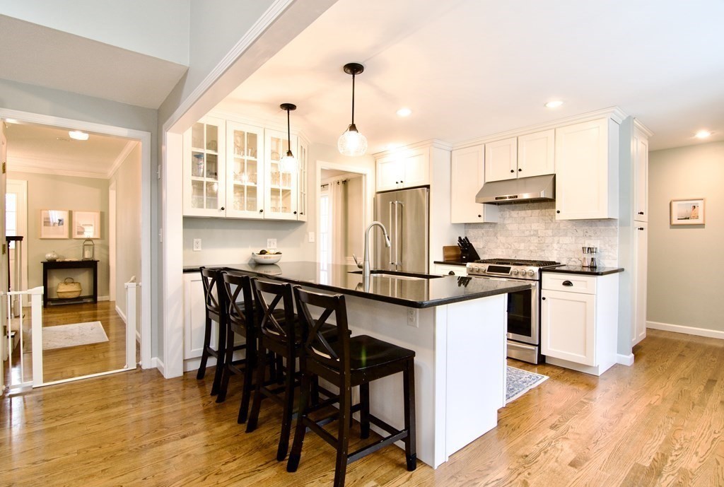 215 Maynard Road Wilbraham, MA 01095 - Photo 6 of 42 a kitchen with stainless steel appliances kitchen island granite countertop a table chairs and a refrigerator