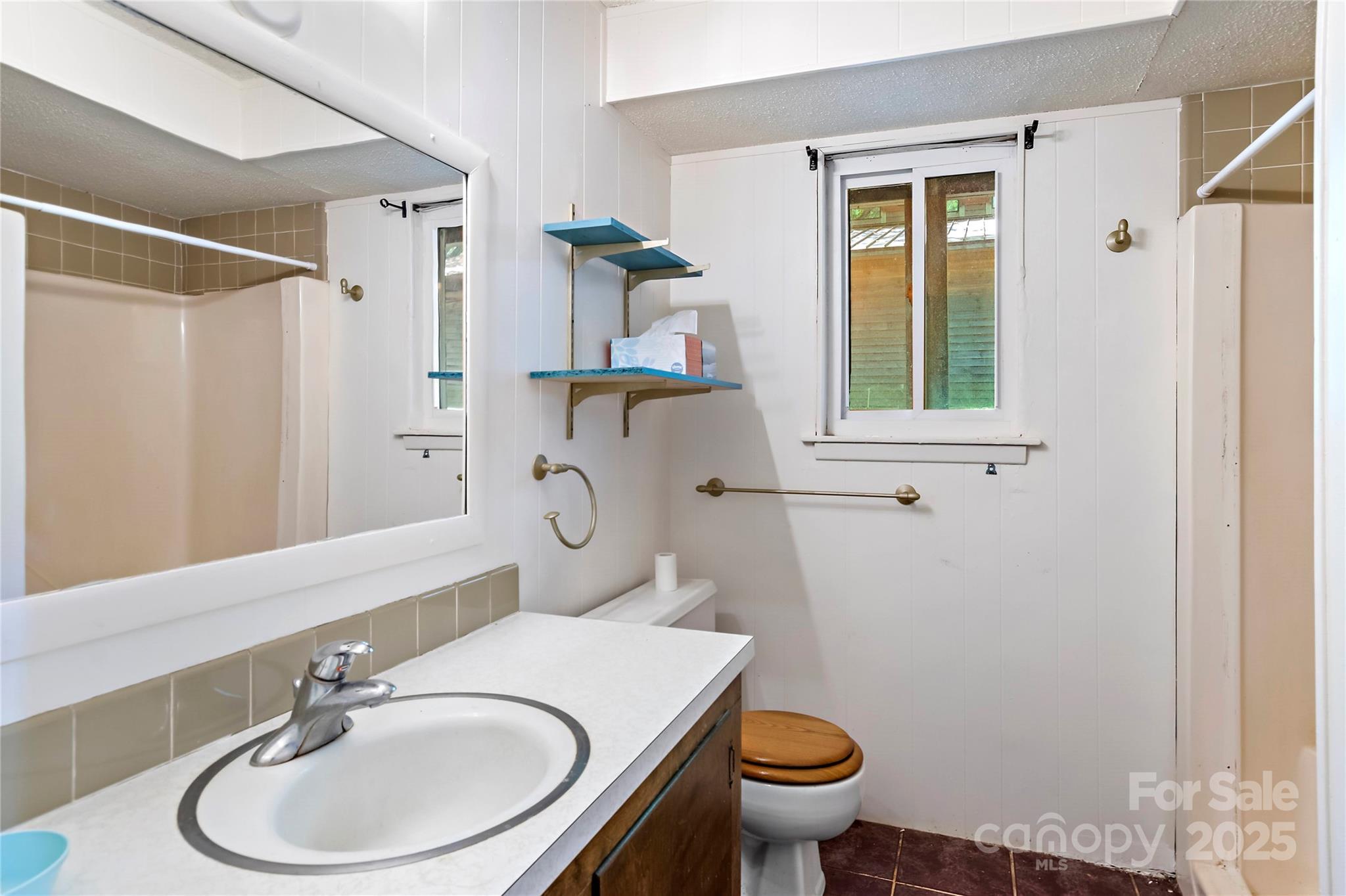 2950 Beroth Road Pfafftown, NC 27040 - Photo 16 of 39 a bathroom with a sink a toilet and a mirror