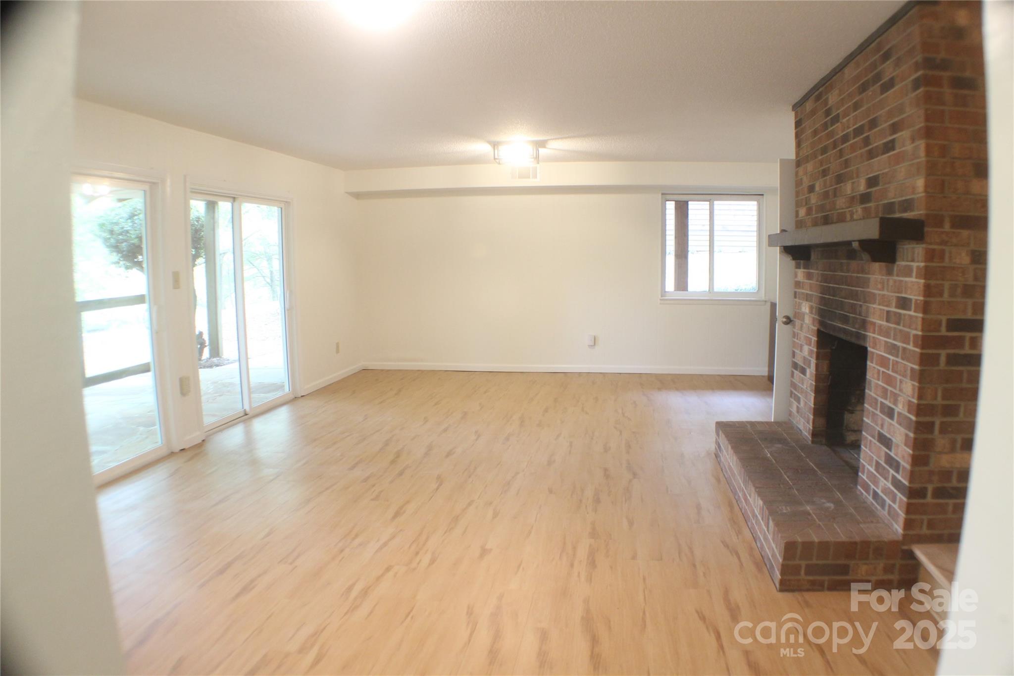 2950 Beroth Road Pfafftown, NC 27040 - Photo 18 of 39 a view of an empty room with wooden floor and a window