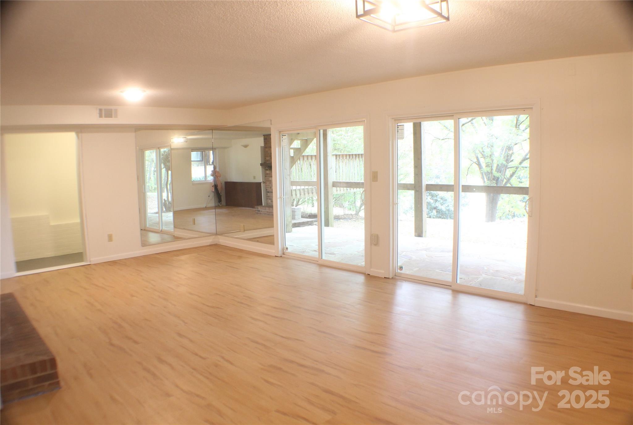 2950 Beroth Road Pfafftown, NC 27040 - Photo 19 of 39 wooden floor in an empty room with a window