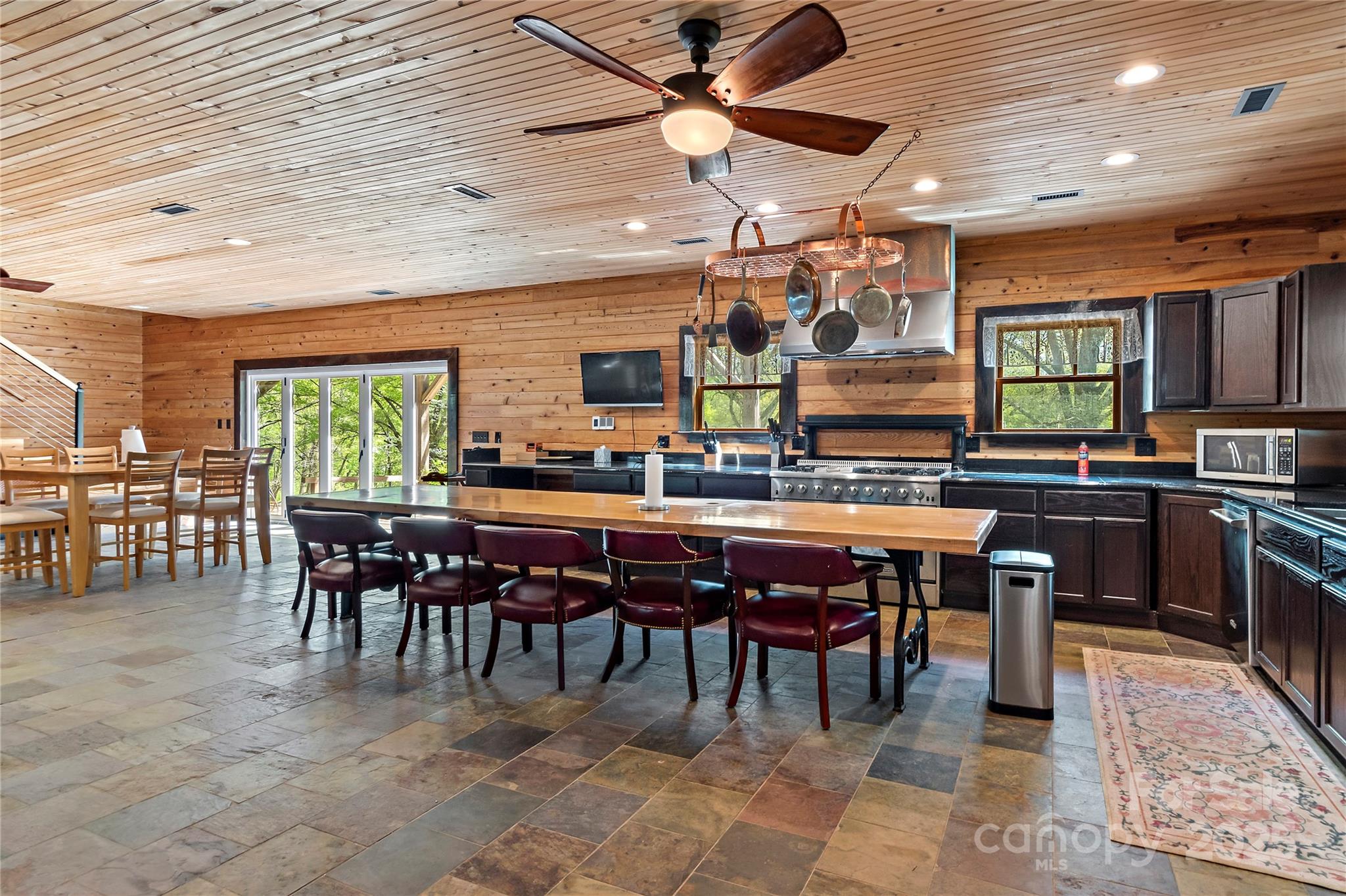 2950 Beroth Road Pfafftown, NC 27040 - Photo 29 of 39 a dining hall with stainless steel appliances kitchen island granite countertop a dining table and chairs
