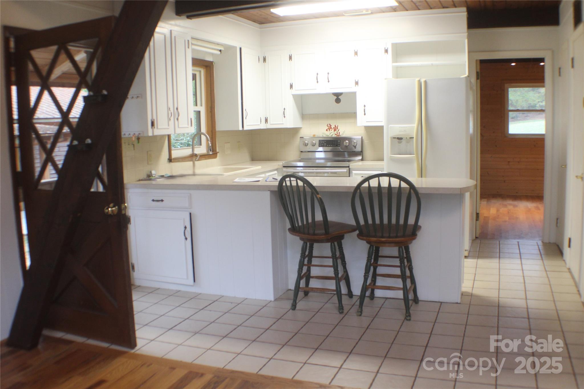 2950 Beroth Road Pfafftown, NC 27040 - Photo 8 of 39 a kitchen with granite countertop a sink cabinets and outdoor space