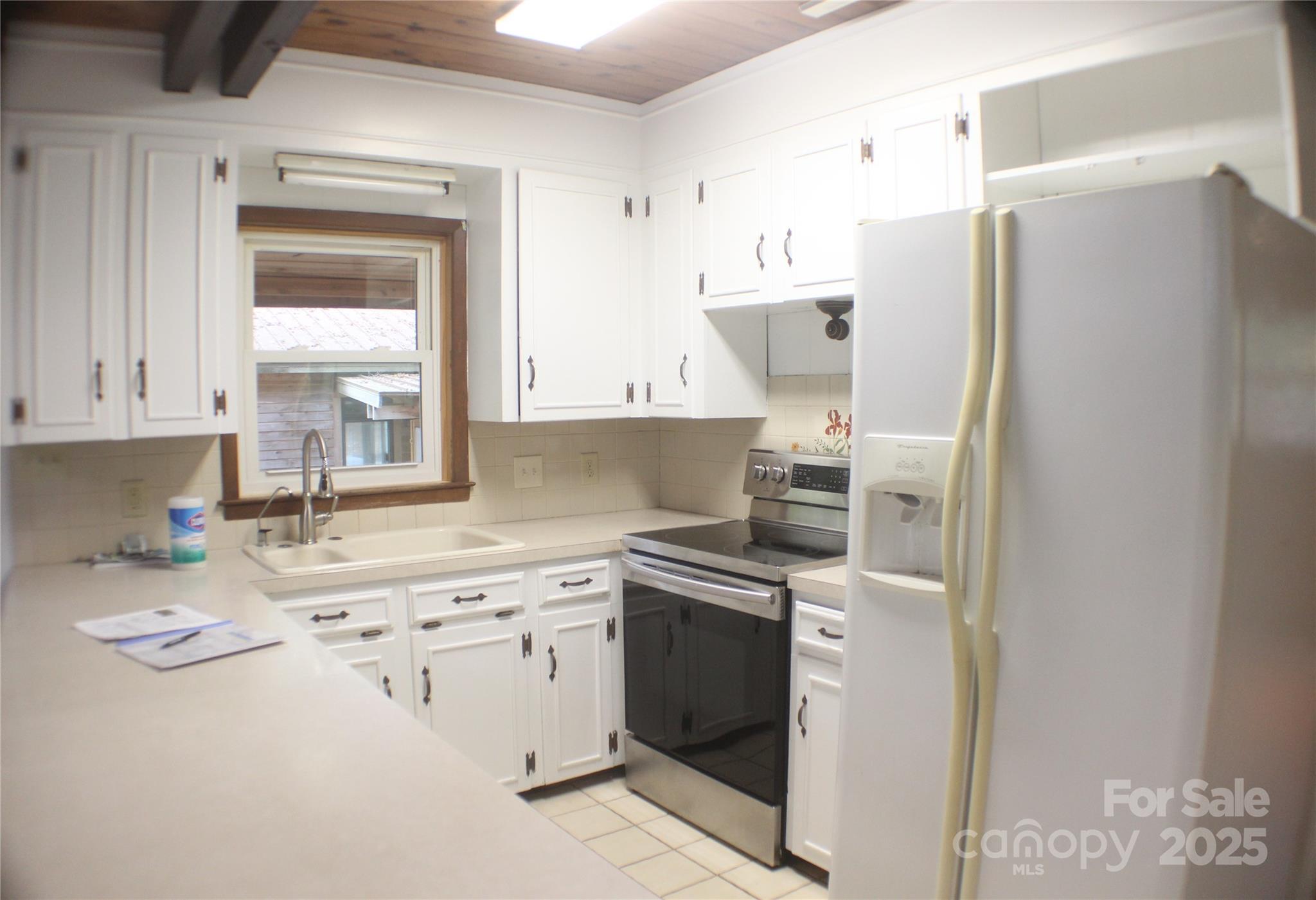 2950 Beroth Road Pfafftown, NC 27040 - Photo 9 of 39 a kitchen with a sink cabinets and stainless steel appliances