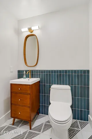 a view of an empty room with wooden floor and a ceiling fan