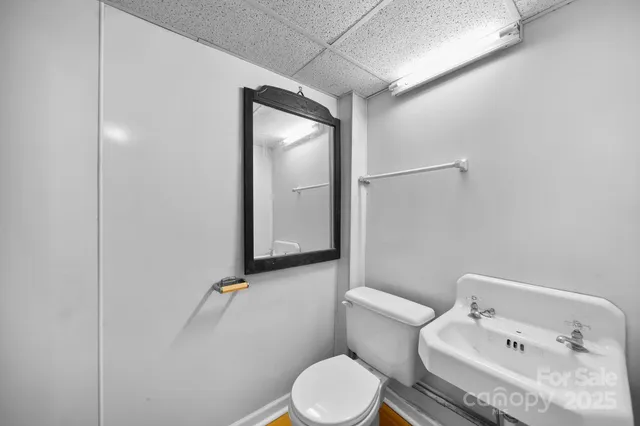 a white toilet sitting next to a bathroom sink