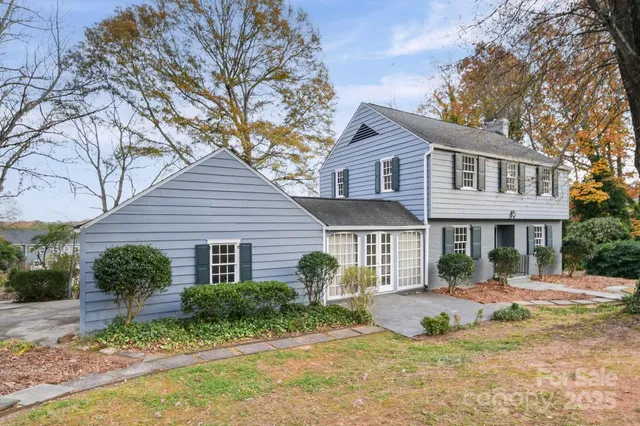 a aerial view of a residential houses with yard