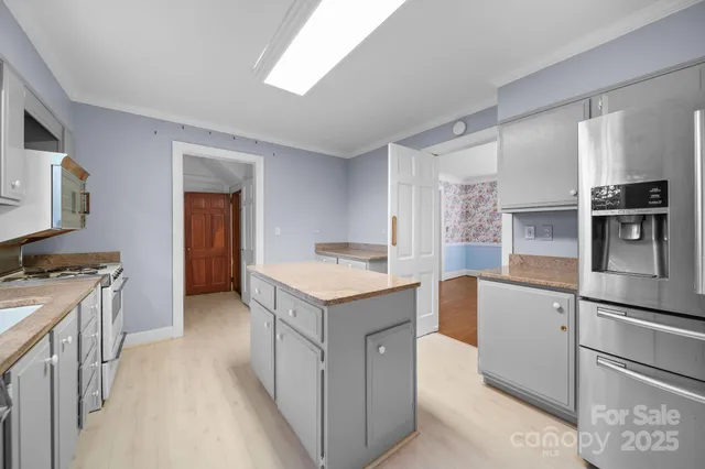 a kitchen with a stove refrigerator and microwave