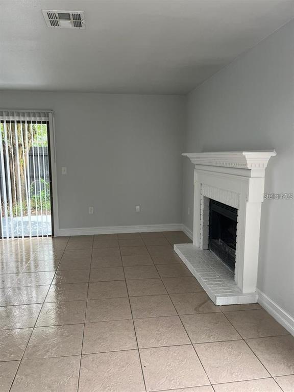 1805 Crystal Grove Drive, Unit 1809 Lakeland, FL 33801 - Photo 4 of 7 a view of an empty room with a fireplace and a window