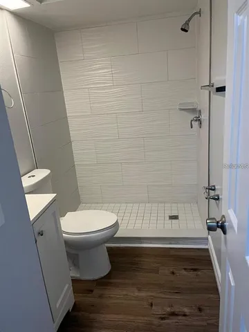 a bathroom with a toilet and a shower