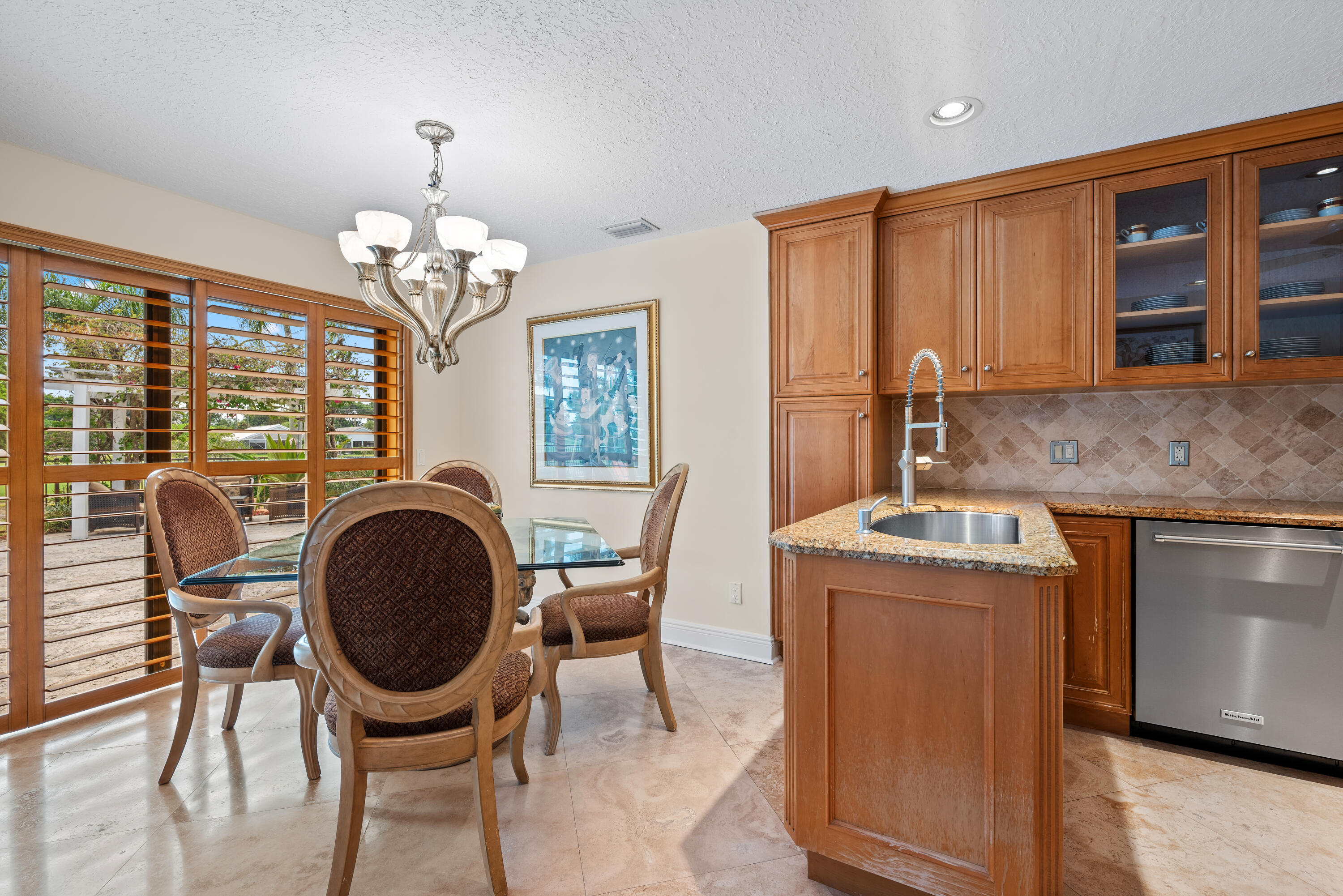 10984 Boca Woods Lane Boca Raton, FL 33428 - Photo 18 of 80 a dining room with furniture a chandelier and wooden floor