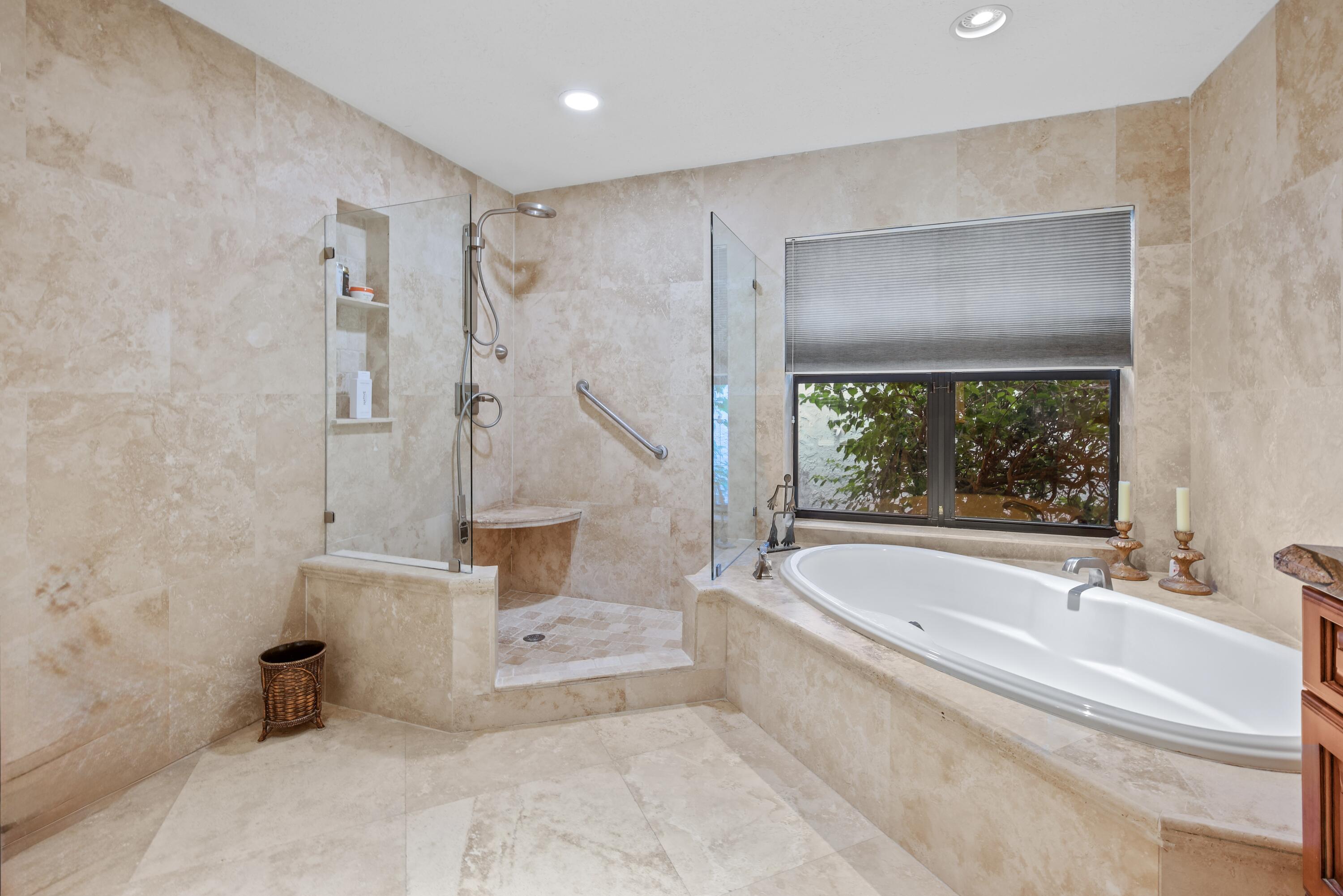 10984 Boca Woods Lane Boca Raton, FL 33428 - Photo 36 of 80 a spacious bathroom with a tub and a large window