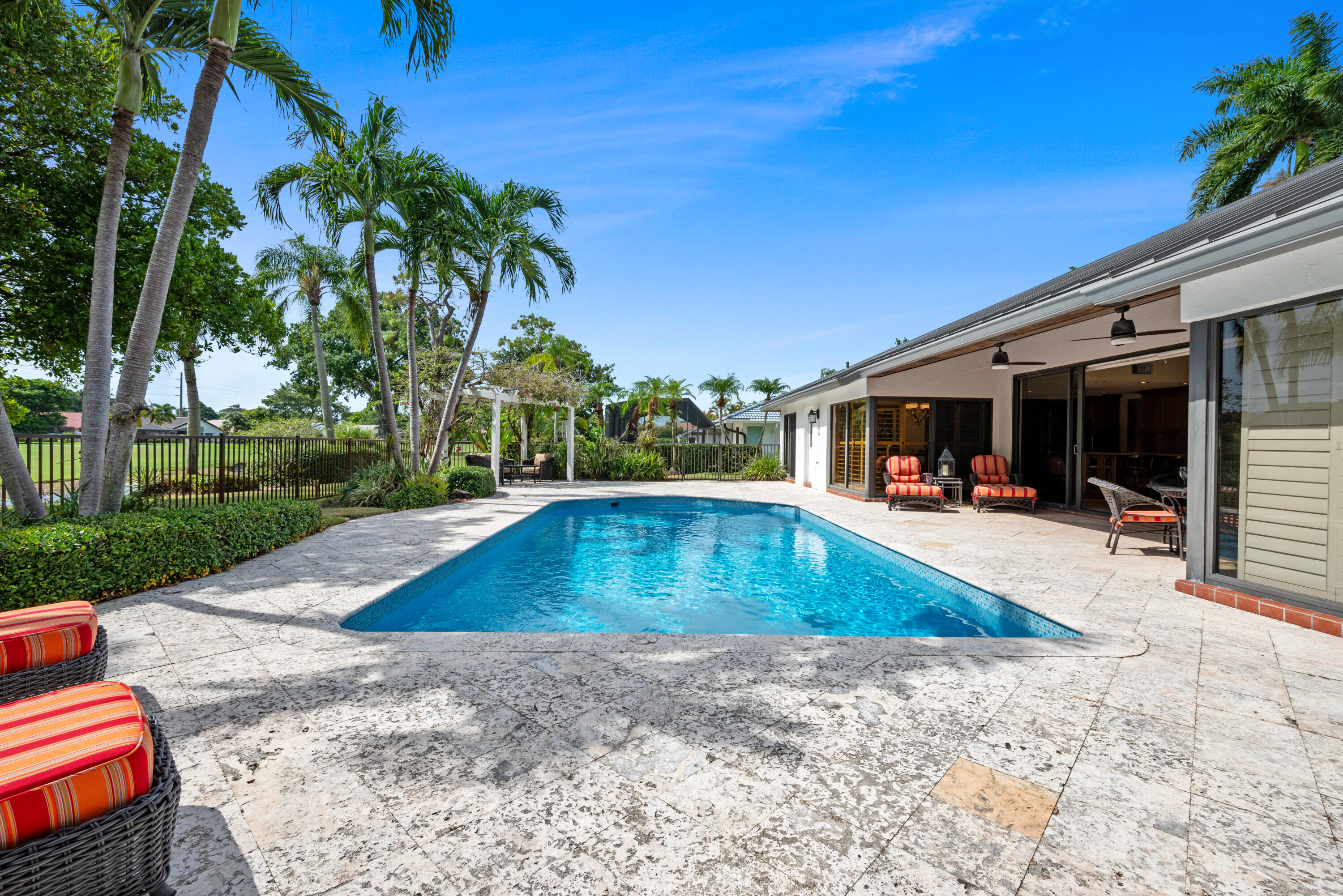 10984 Boca Woods Lane Boca Raton, FL 33428 - Photo 50 of 80 a view of swimming pool with lawn chairs and plants