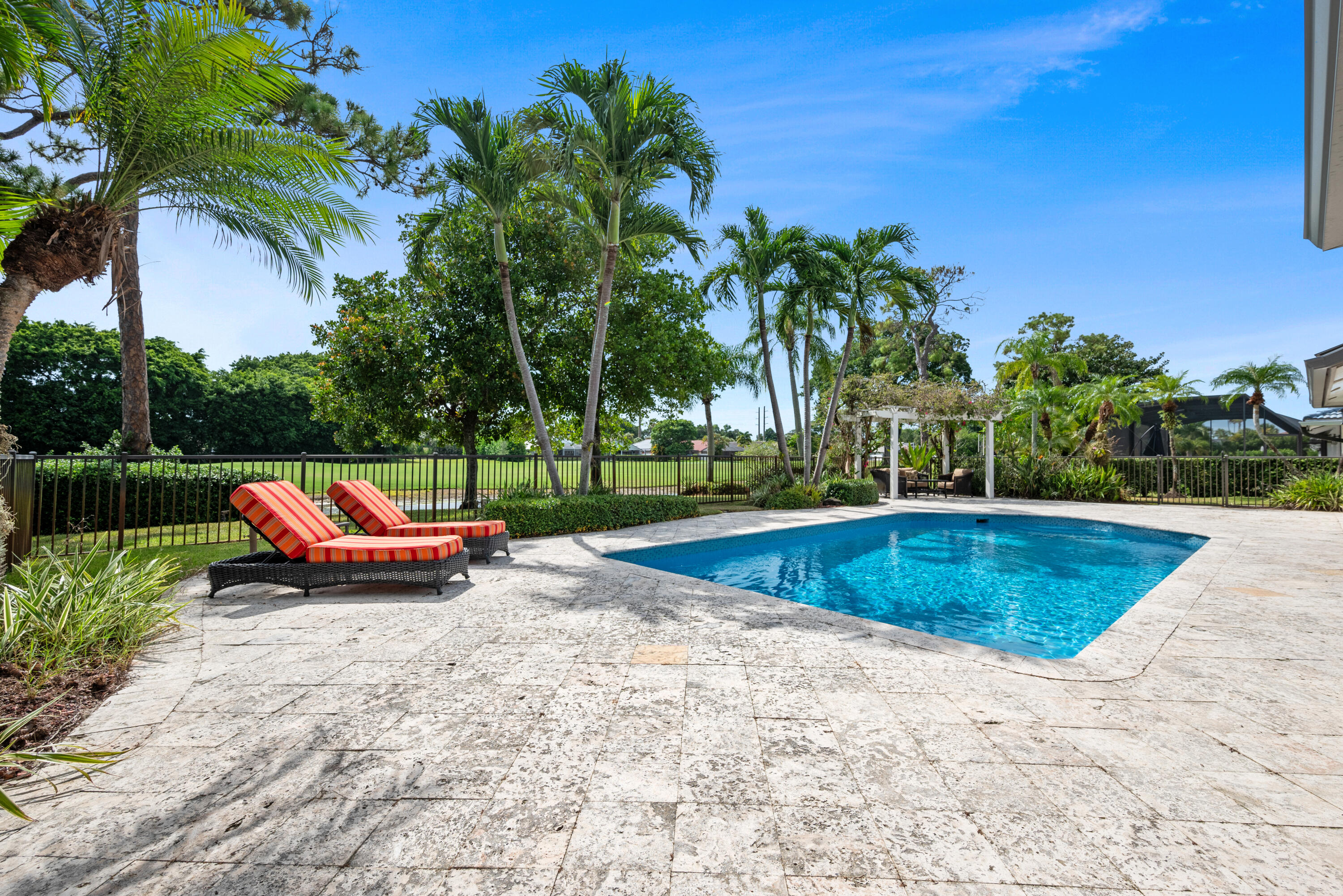 10984 Boca Woods Lane Boca Raton, FL 33428 - Photo 51 of 80 a view of swimming pool with a bench and trees