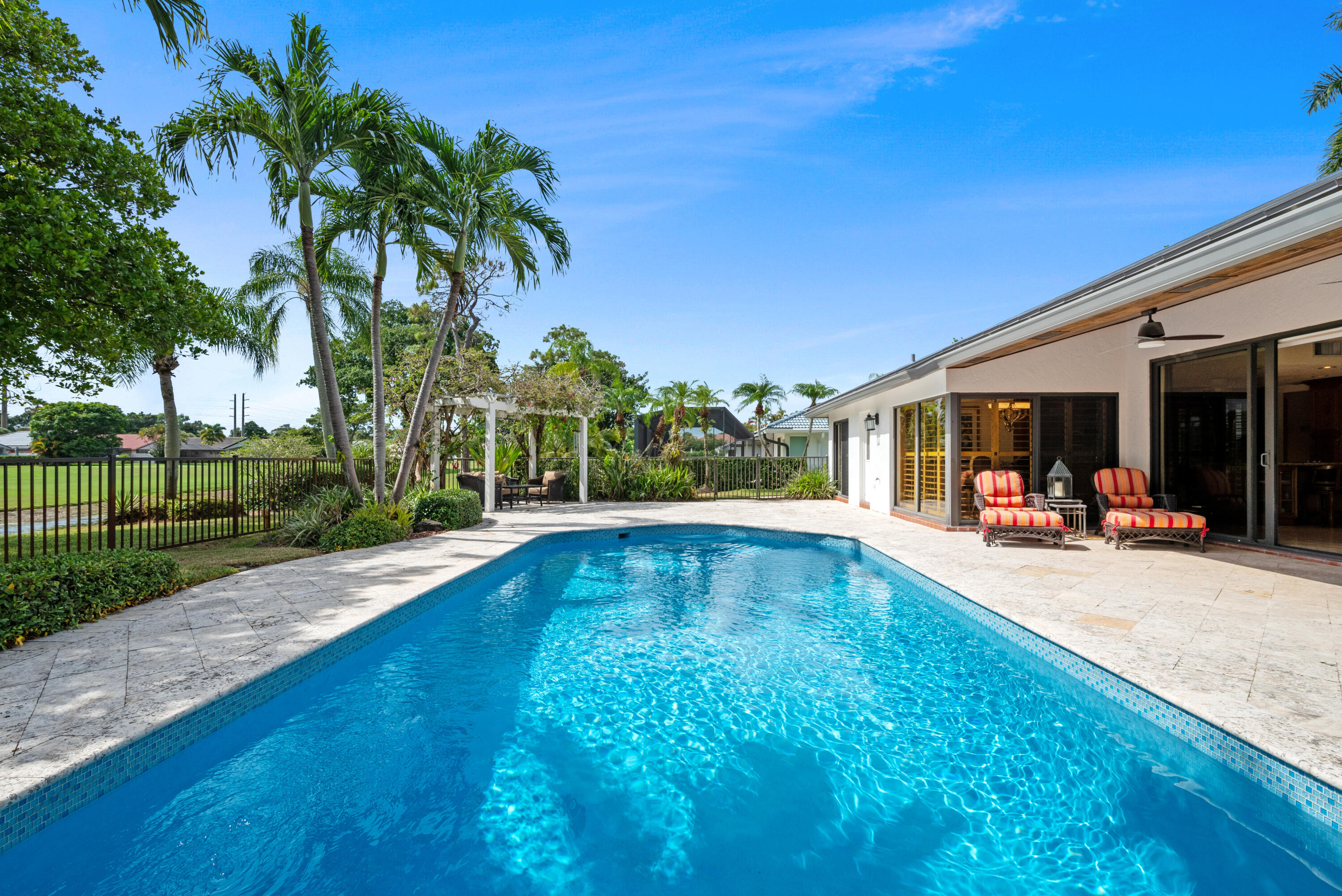 10984 Boca Woods Lane Boca Raton, FL 33428 - Photo 6 of 80 a view of a backyard with a patio and swimming pool