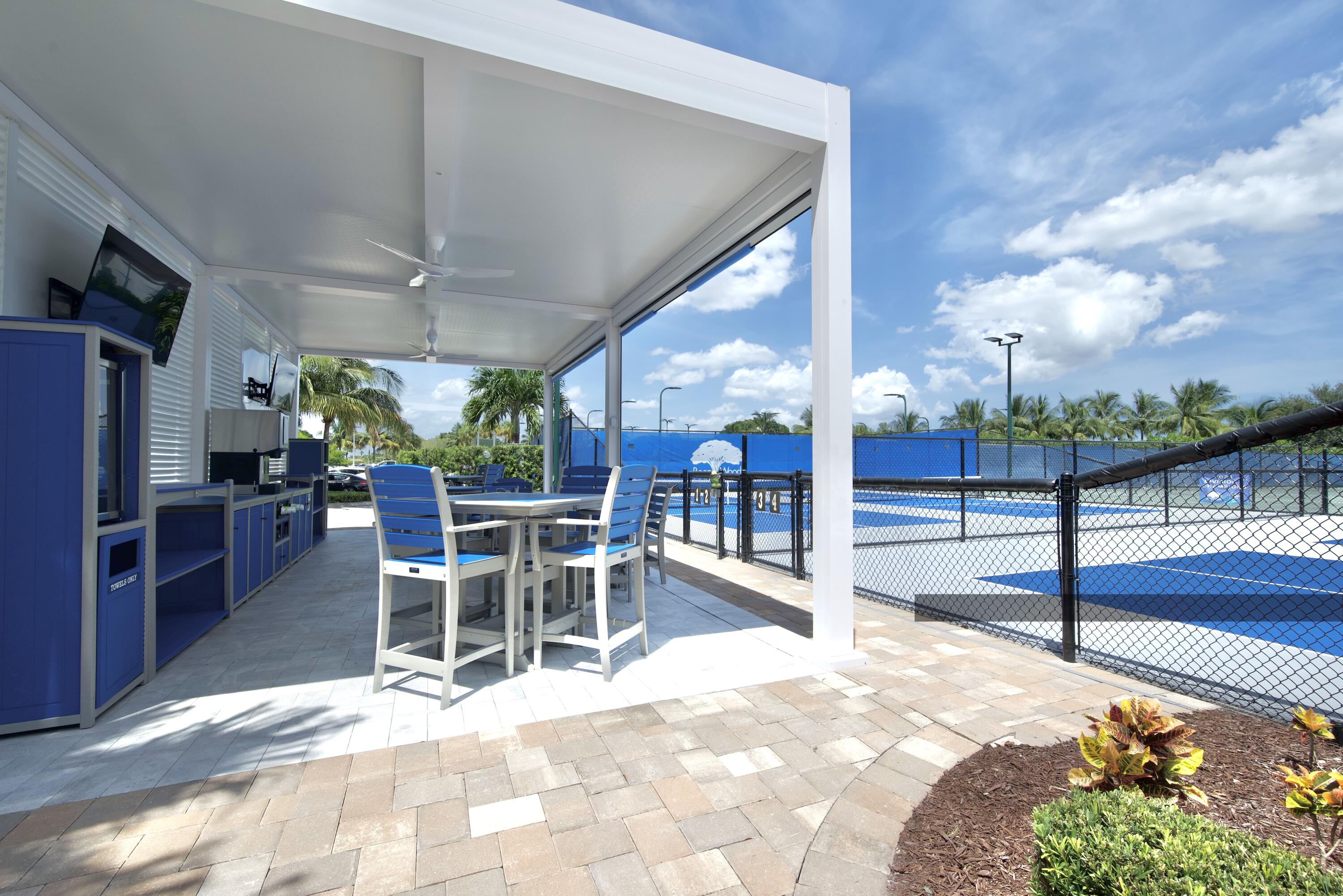 10984 Boca Woods Lane Boca Raton, FL 33428 - Photo 63 of 80 a view of a patio with a table and chairs