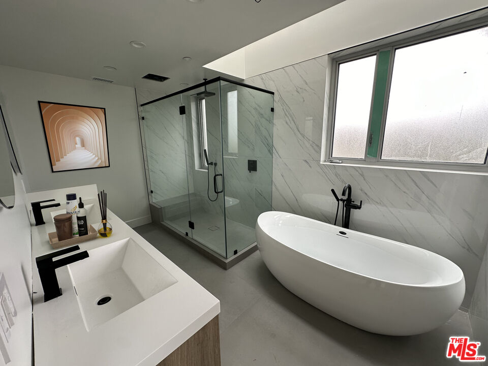 1900 20th Street, Unit B Santa Monica, CA 90404 - Photo 6 of 14 a bathroom with a sink a toilet and shower