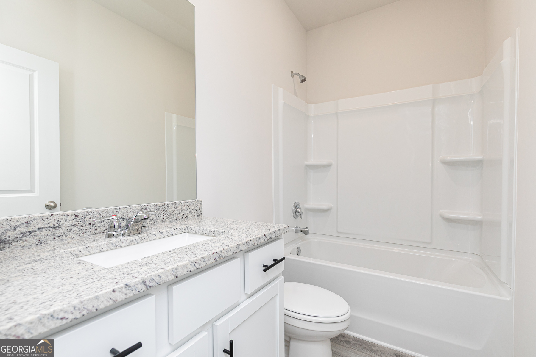 526 Plant Road Conyers, GA 30013 - Photo 11 of 11 a bathroom with a granite countertop sink a toilet and bathtub