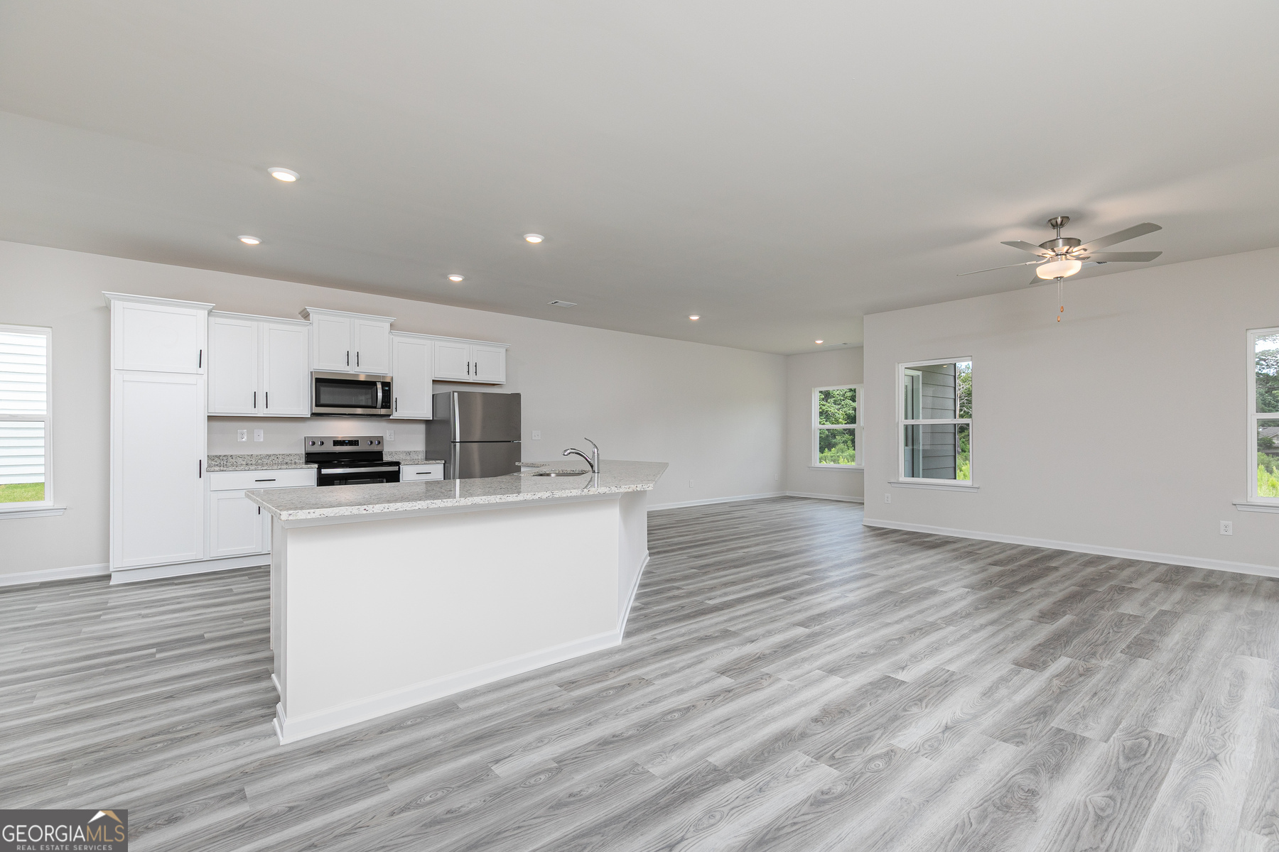 526 Plant Road Conyers, GA 30013 - Photo 4 of 11 a view of kitchen with stainless steel appliances granite countertop a white stove top oven and a refrigerator