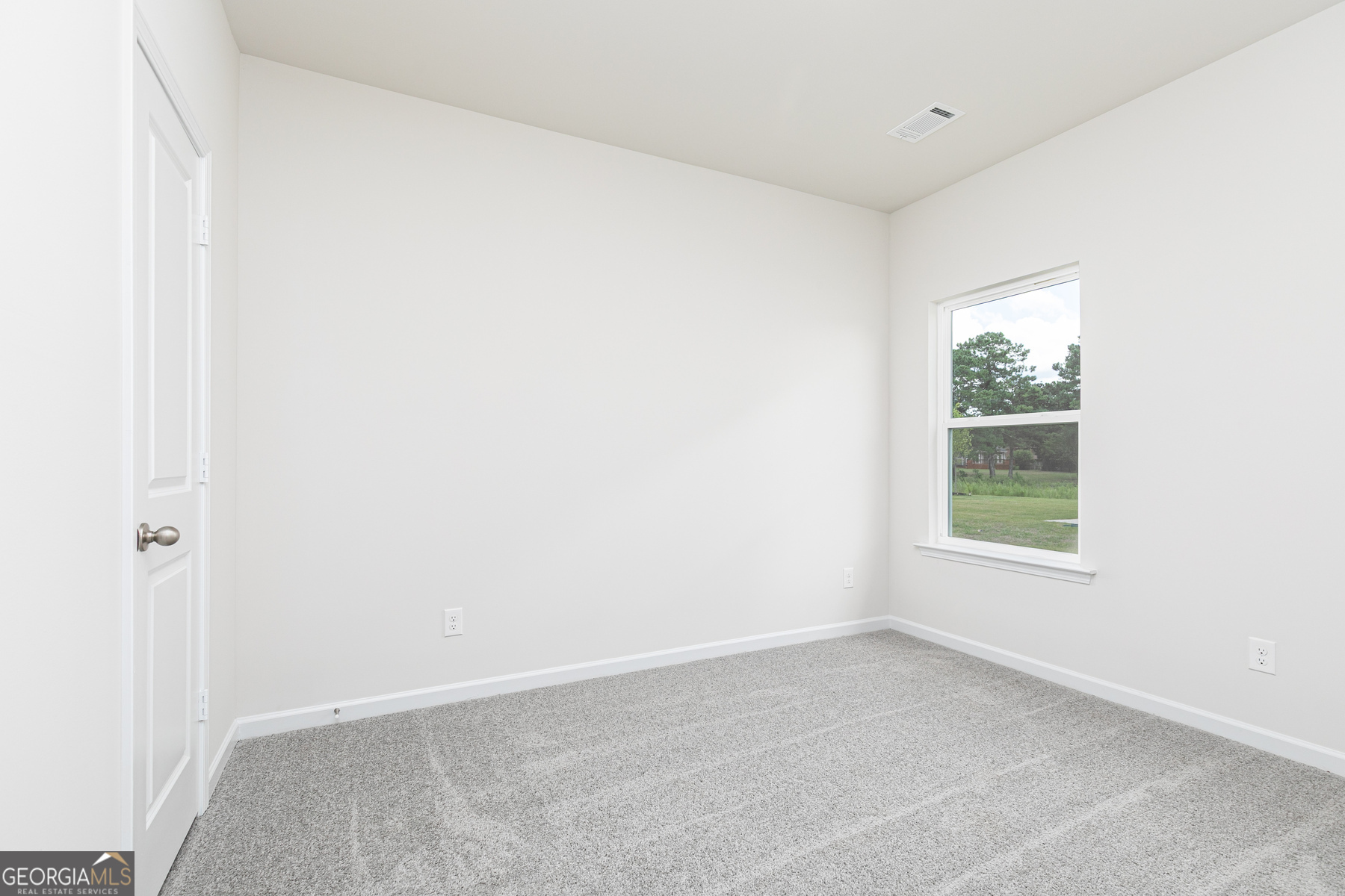 526 Plant Road Conyers, GA 30013 - Photo 8 of 11 an empty room with a window