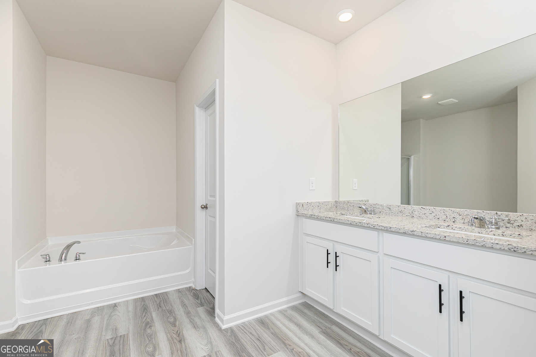526 Plant Road Conyers, GA 30013 - Photo 10 of 11 a bathroom with a granite countertop sink and a bathtub