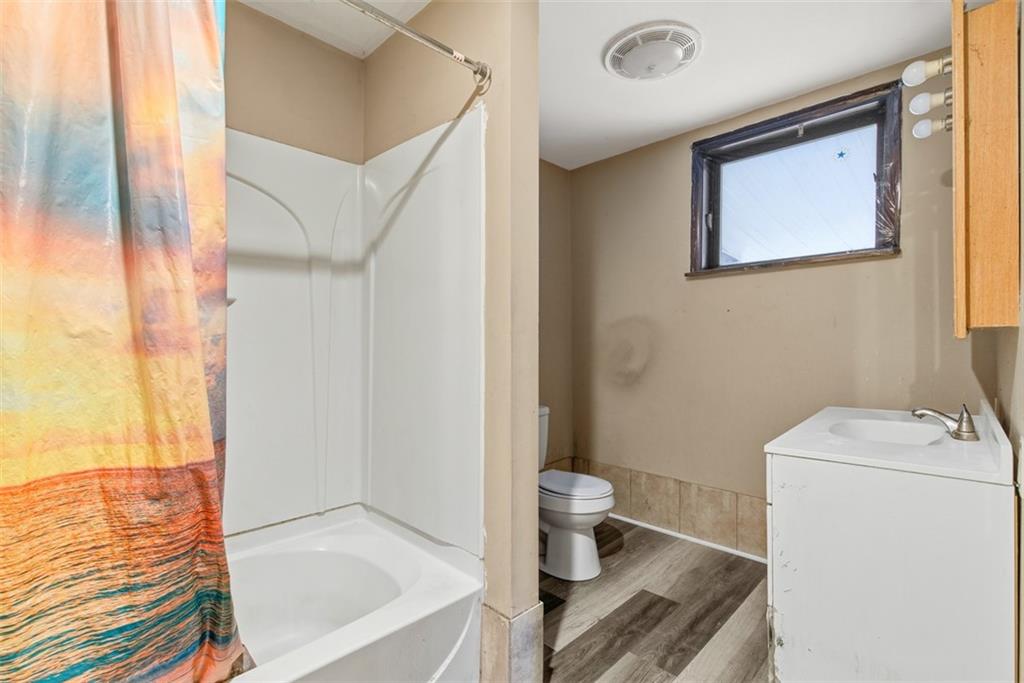 1057 Keene Street Springdale, PA 15144 - Photo 16 of 50 a bathroom with a sink toilet and shower