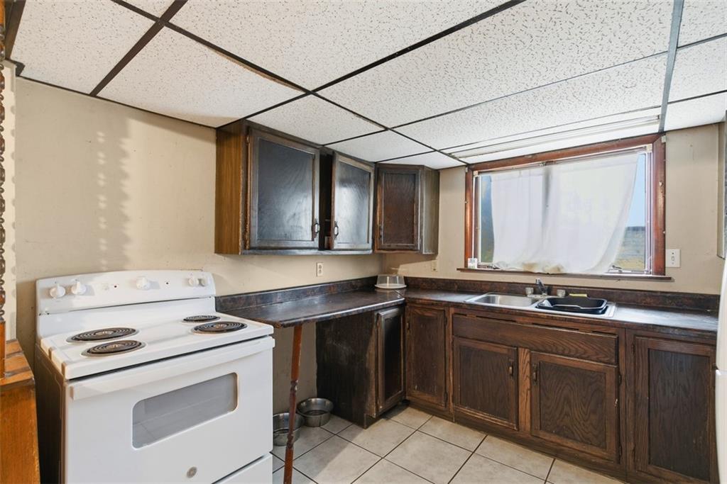 1057 Keene Street Springdale, PA 15144 - Photo 17 of 50 a kitchen with a stove and a sink