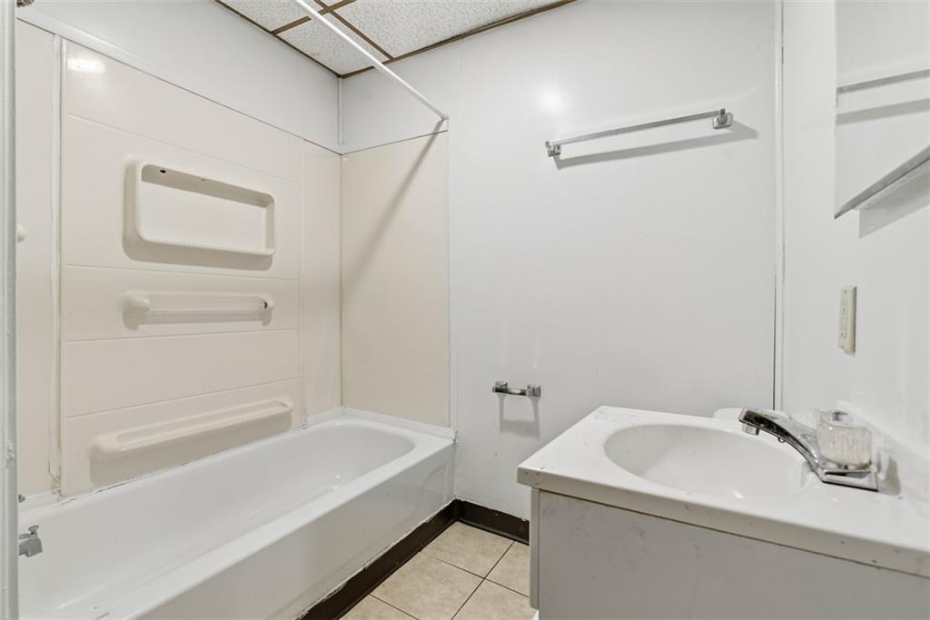 1057 Keene Street Springdale, PA 15144 - Photo 29 of 50 a bathroom with a sink and a bathtub