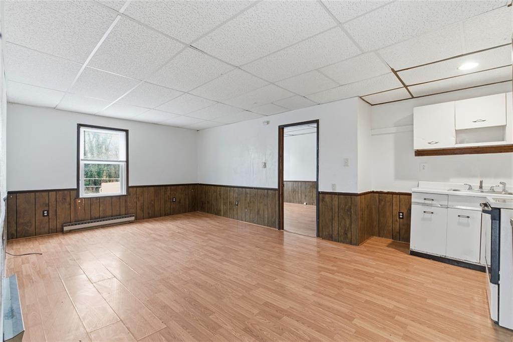 1057 Keene Street Springdale, PA 15144 - Photo 32 of 50 a view of a big room with wooden floor and cabinet