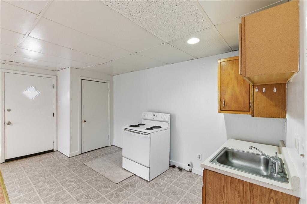 1057 Keene Street Springdale, PA 15144 - Photo 36 of 50 a kitchen that has a sink and a stove