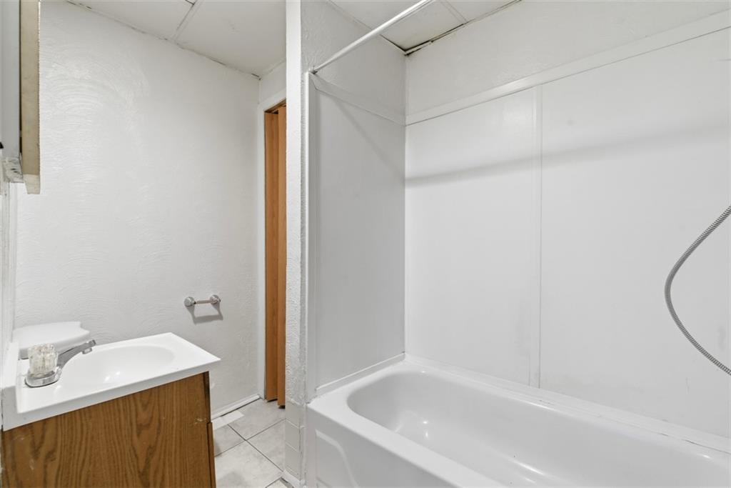 1057 Keene Street Springdale, PA 15144 - Photo 41 of 50 a bathroom with a tub and a sink